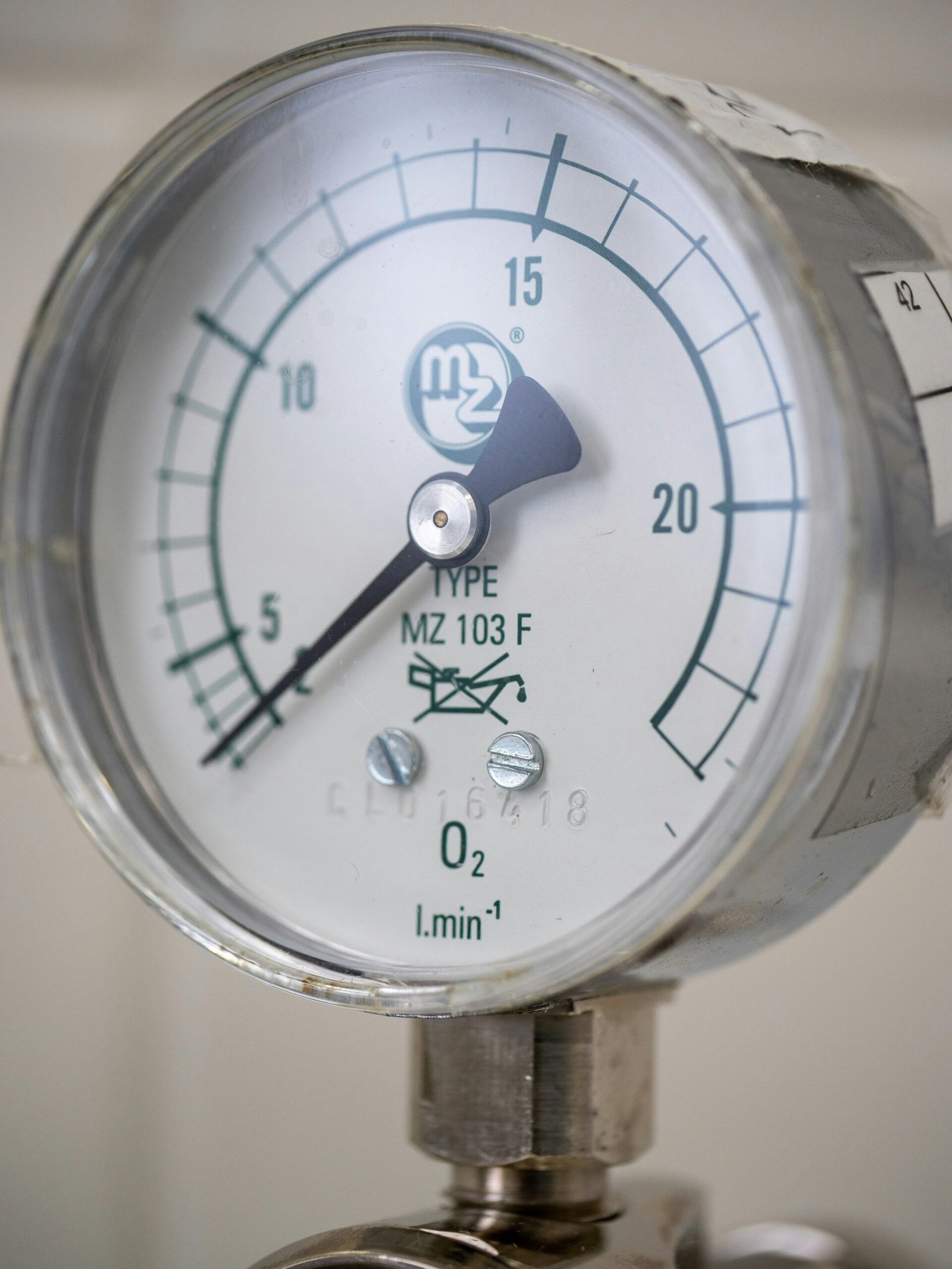 A close up of a pressure gauge on a pipe